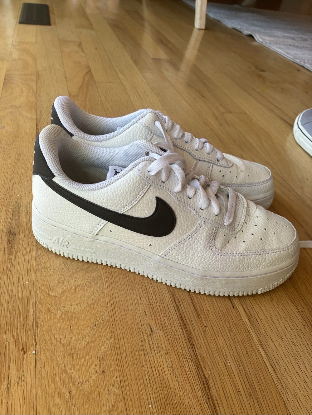 Nike Women’s Low-Top Sneakers in White with Black Swoosh